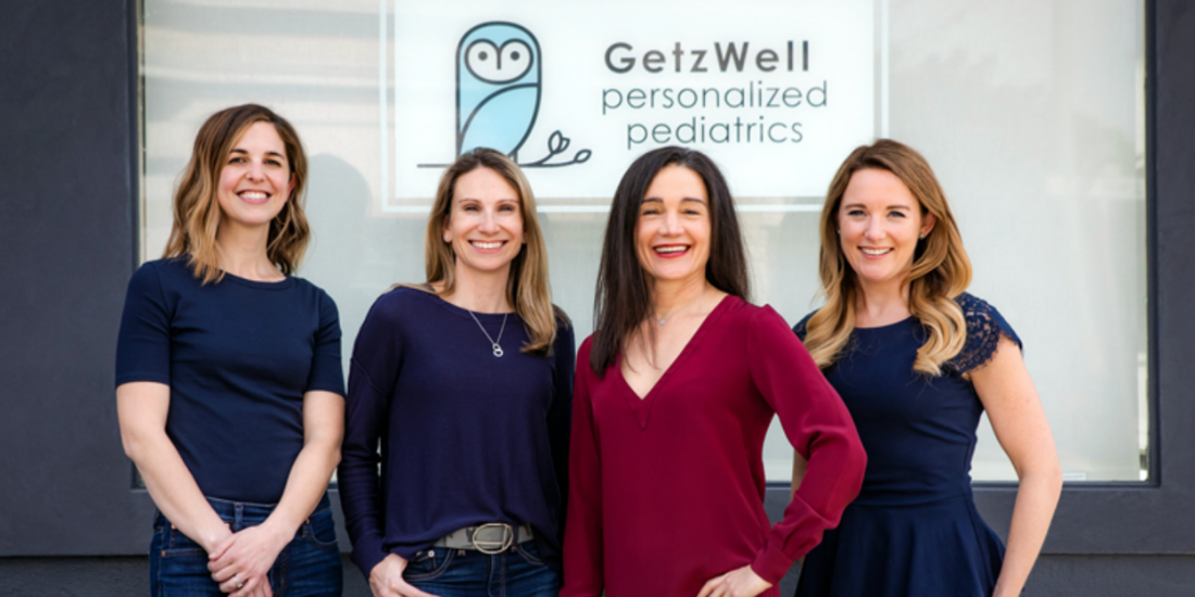 Holistic Pediatricians in San Francisco stand in front of pediatrician office GetzWell with owl sign.