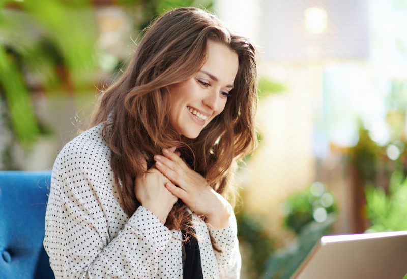 Image of happy woman in online therapy appointment